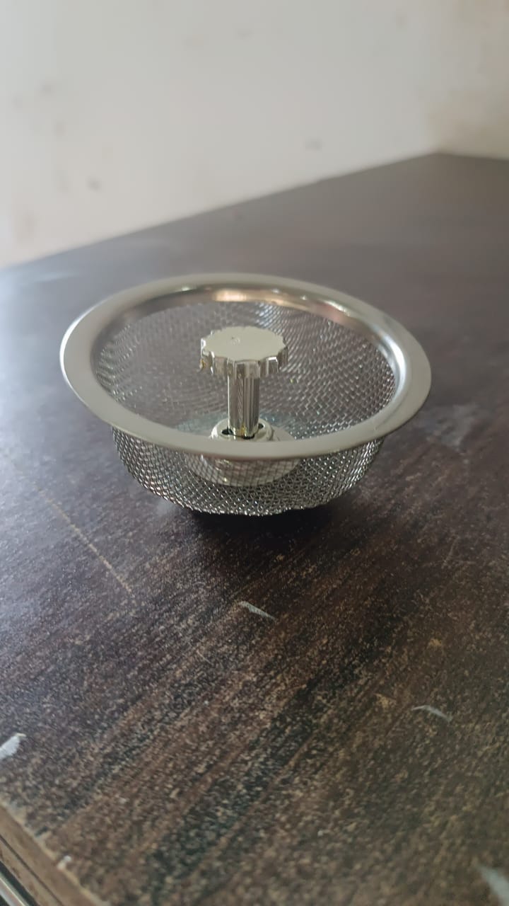 Angled view of the polished stainless steel kitchen sink strainer.