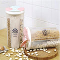 A transparent 4 section kitchen storage jar with a red lid, filled with various dry foods like cereals and pulses, by Organivo.