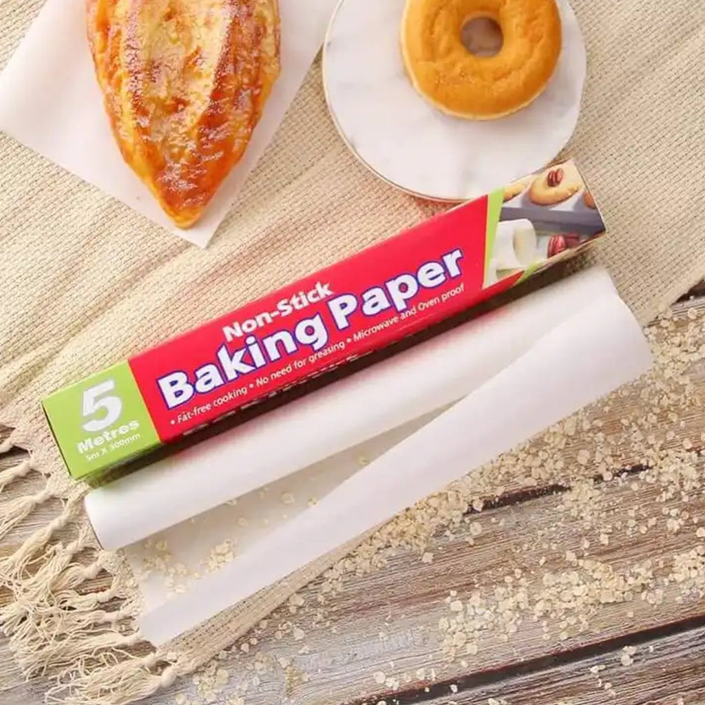 Food baking in an oven on a sheet of non-stick parchment paper for easy cleanup.