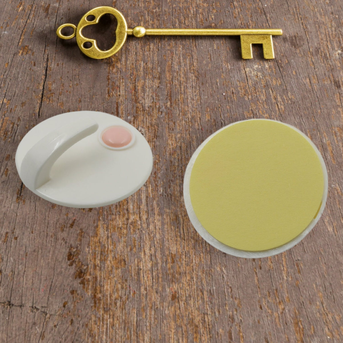 GlimmerHome self-adhesive hooks neatly organizing kitchen towels and spatulas on a tiled wall.