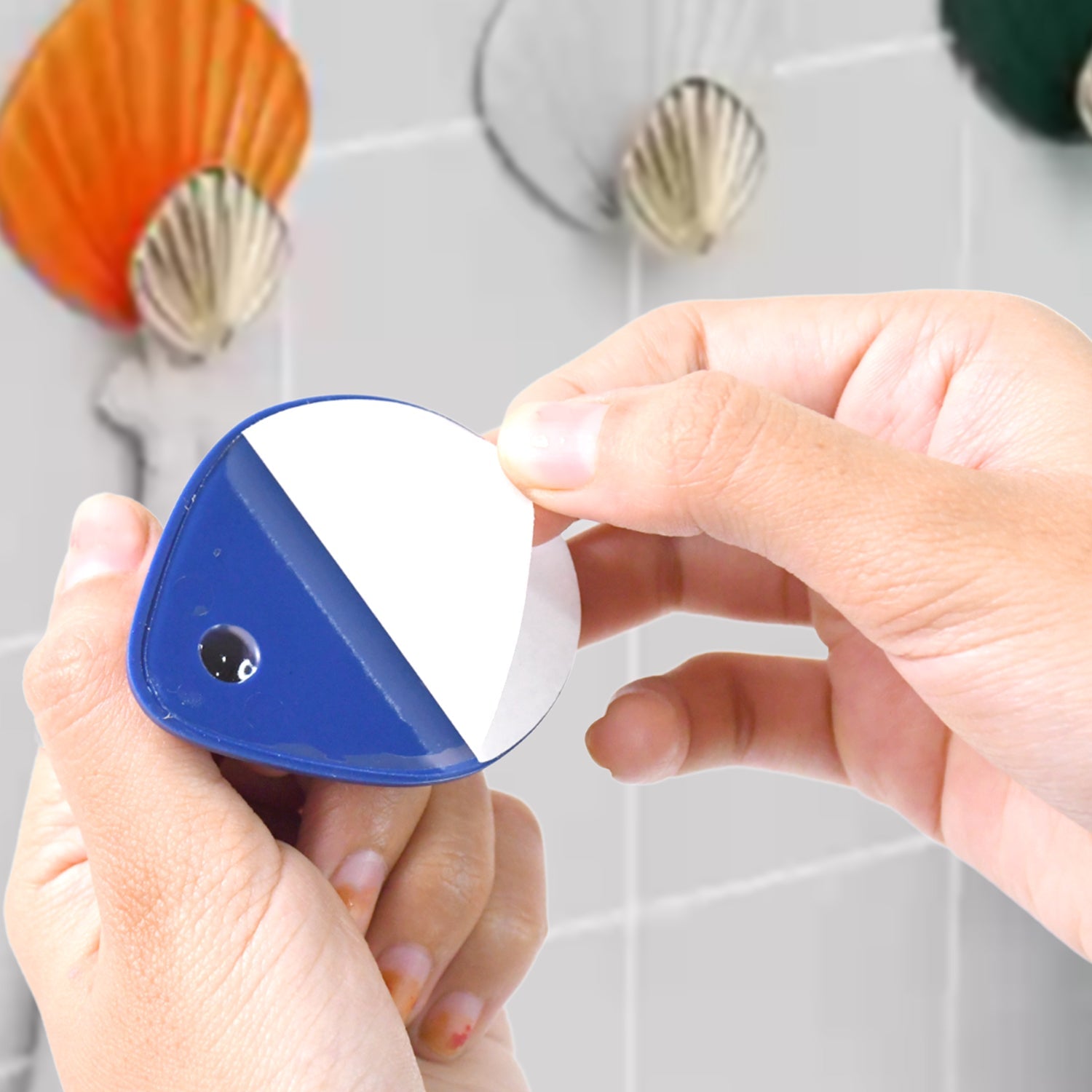 Colorful plastic adhesive wall hooks designed for easy peel-and-stick application