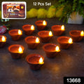 A close-up of a water sensor diya illuminating a rangoli design.