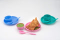 Multipurpose snack set with a bowl, dish, and spoon in a vibrant color, ready for use.