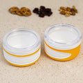 Two clear plastic airtight food containers with blue lids, stacked neatly.