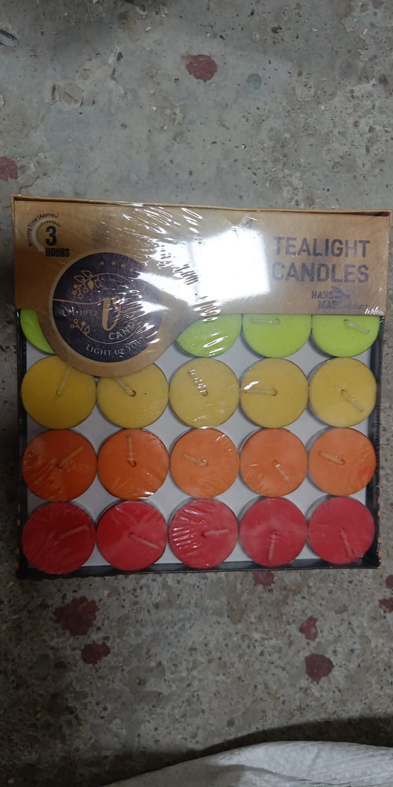 Colorful decorative tealight candles in a 50-piece pack, ready for celebrations.