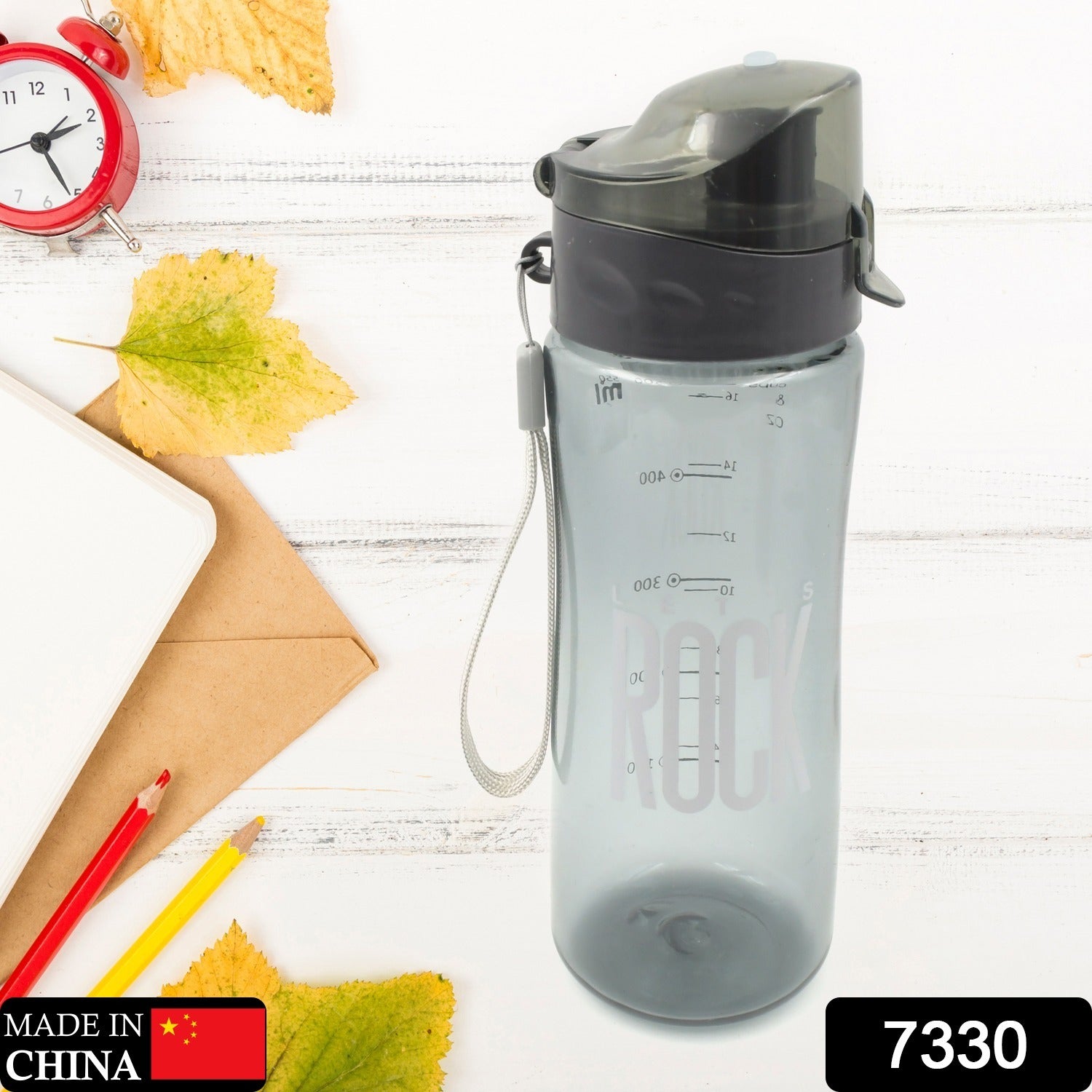 Side view of a plastic sports water bottle in an outdoor setting.