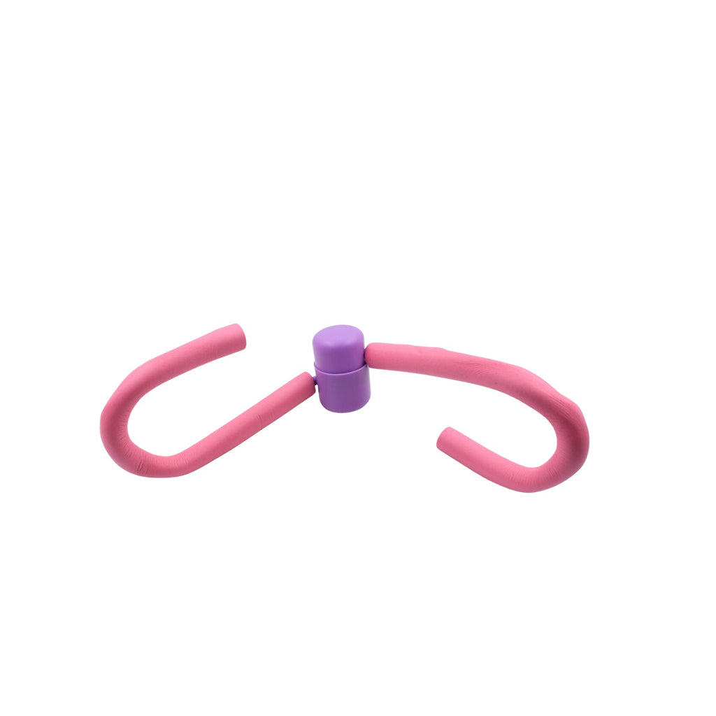 The Thigh Toner positioned next to other gym equipment, highlighting its compact size.