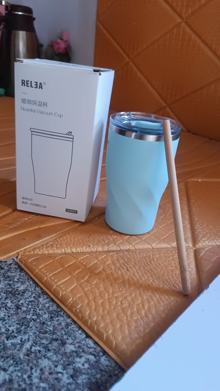 Portable stainless steel insulated coffee mug with wooden straw, ideal for travel