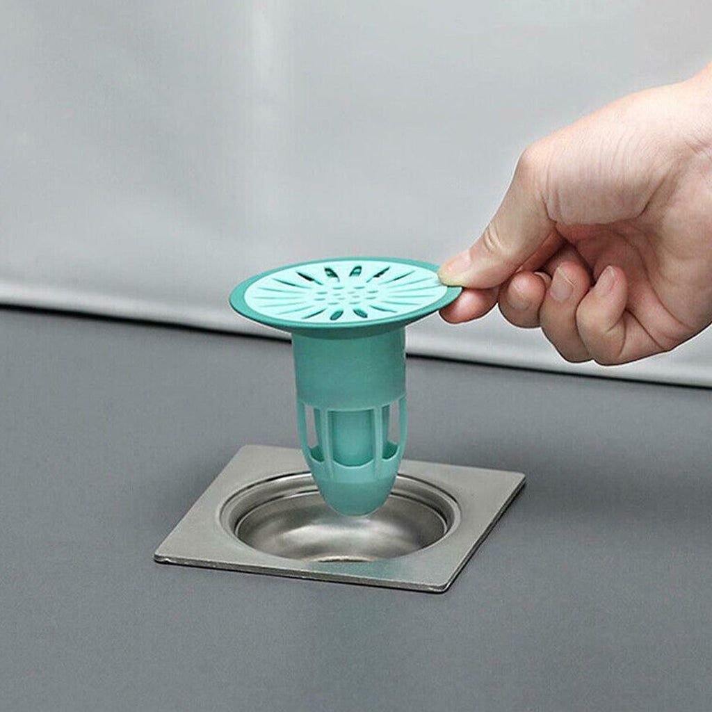 Silicone floor drain stopper preventing hair and odors in a modern bathroom.