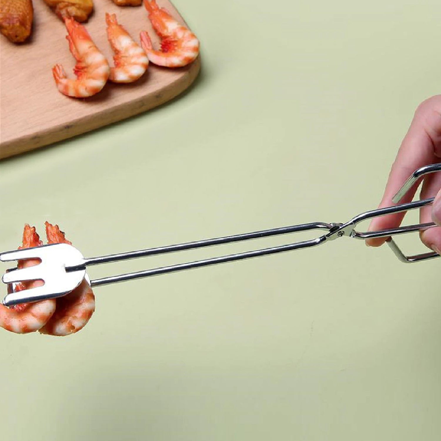 Long metal BBQ serving clamp suitable for various kitchen tasks.