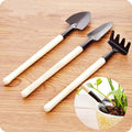 Kids Garden Tools Set of 3 pieces, including a yellow trowel, blue shovel, and green rake.