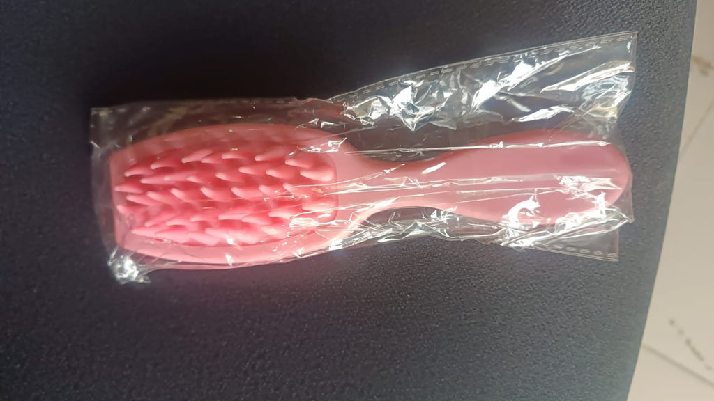 Person using silicone scalp massager on wet hair during shampoo