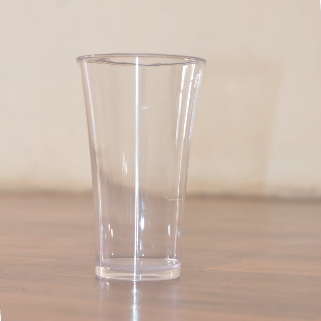 Stack of transparent plastic water glasses for compact storage.