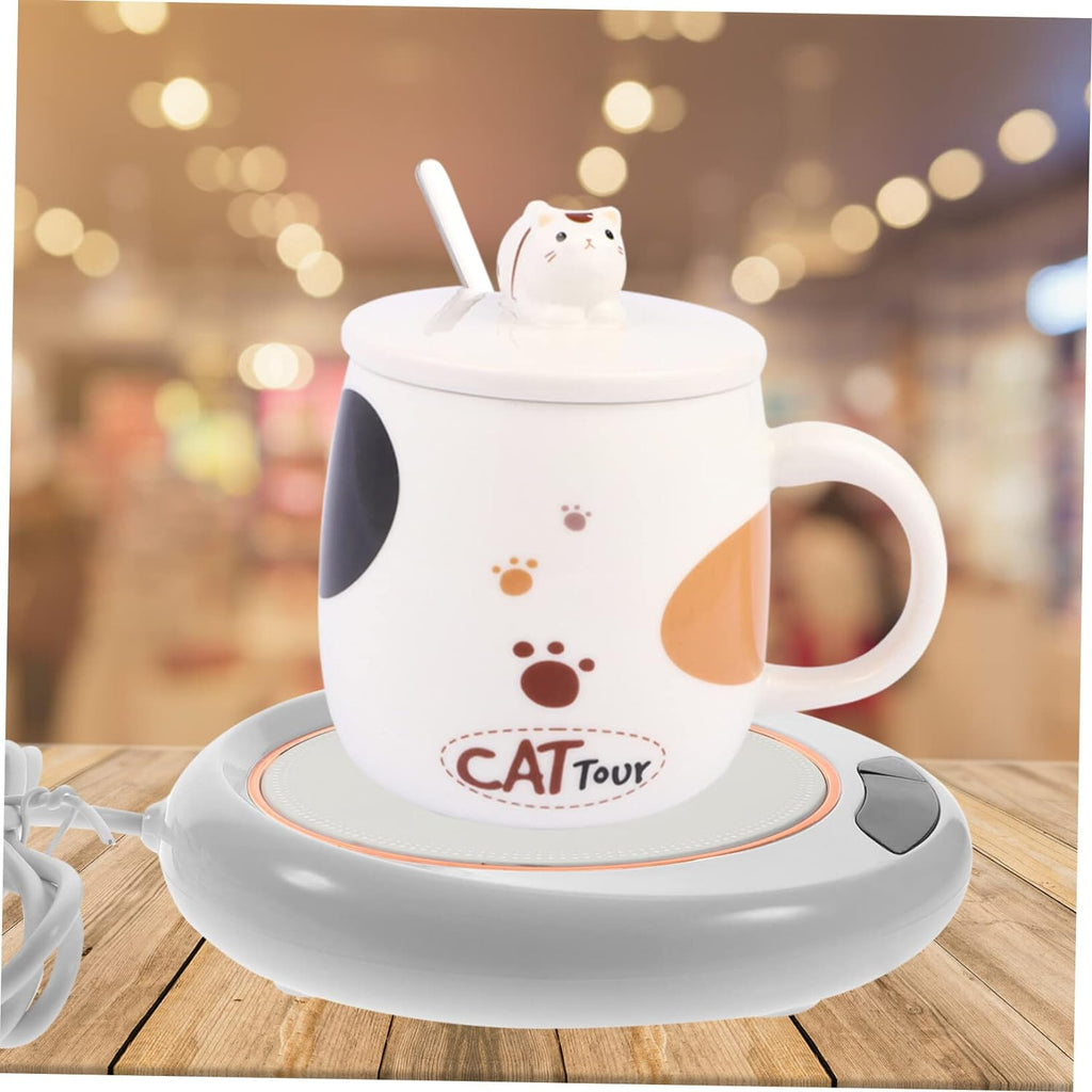 USB mug warmer keeping a coffee cup warm on a wooden desk.