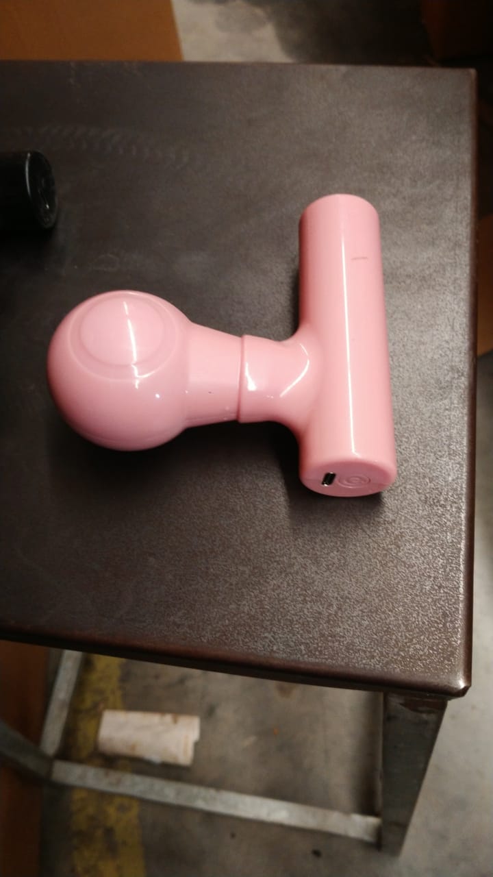 Black mini body massager presented in its retail box packaging.