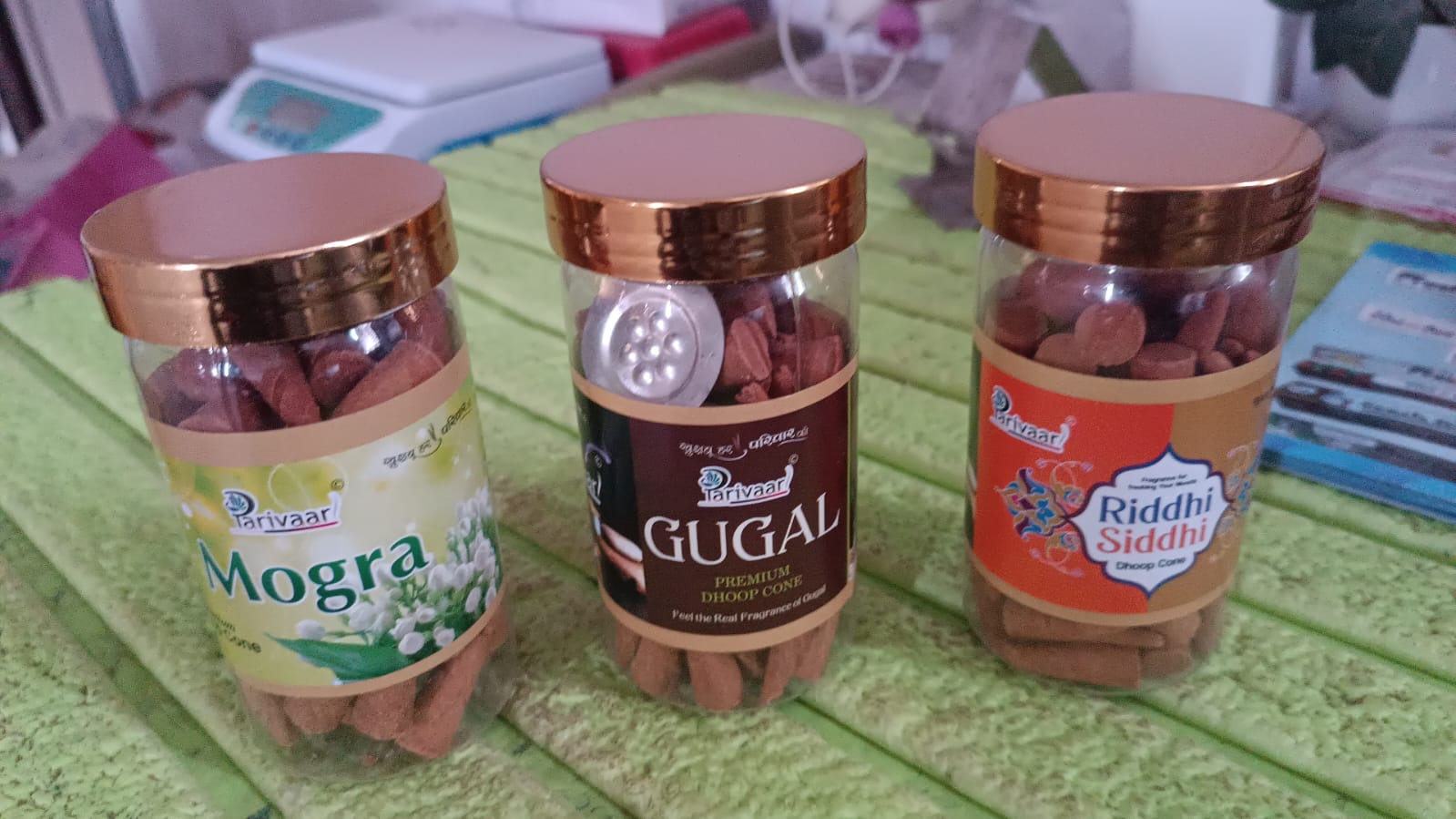 Assortment of Indo Glow mix flavour dhoop cones in a clear container.