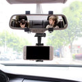 Car Rear View Mobile Holder securely gripping a smartphone.