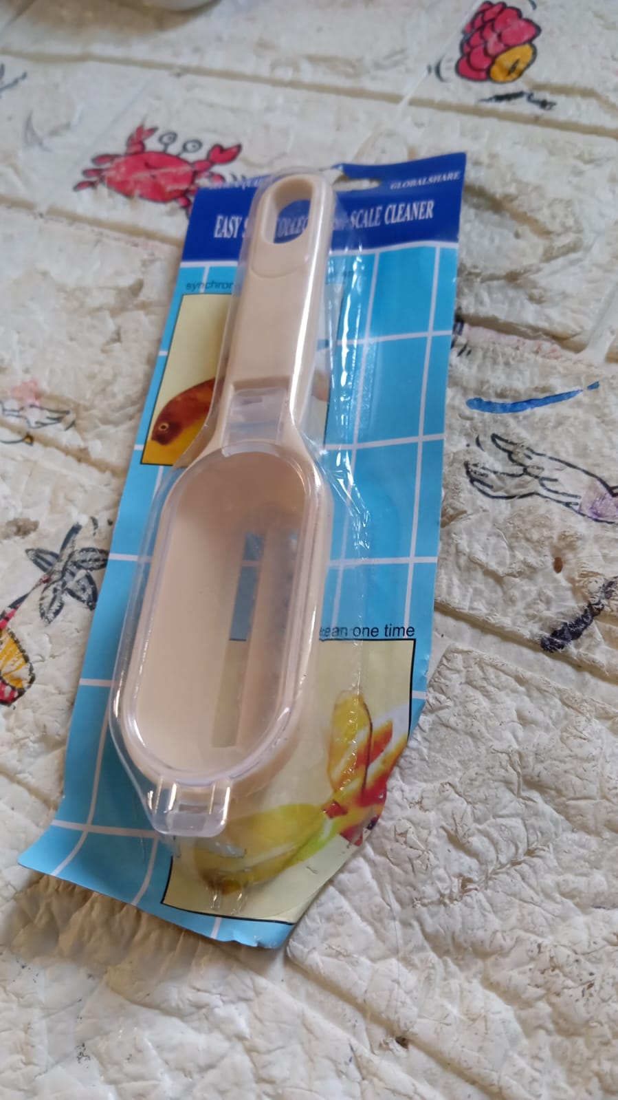 Compact fish scale scraper, grater, and brush for quick cleanup.