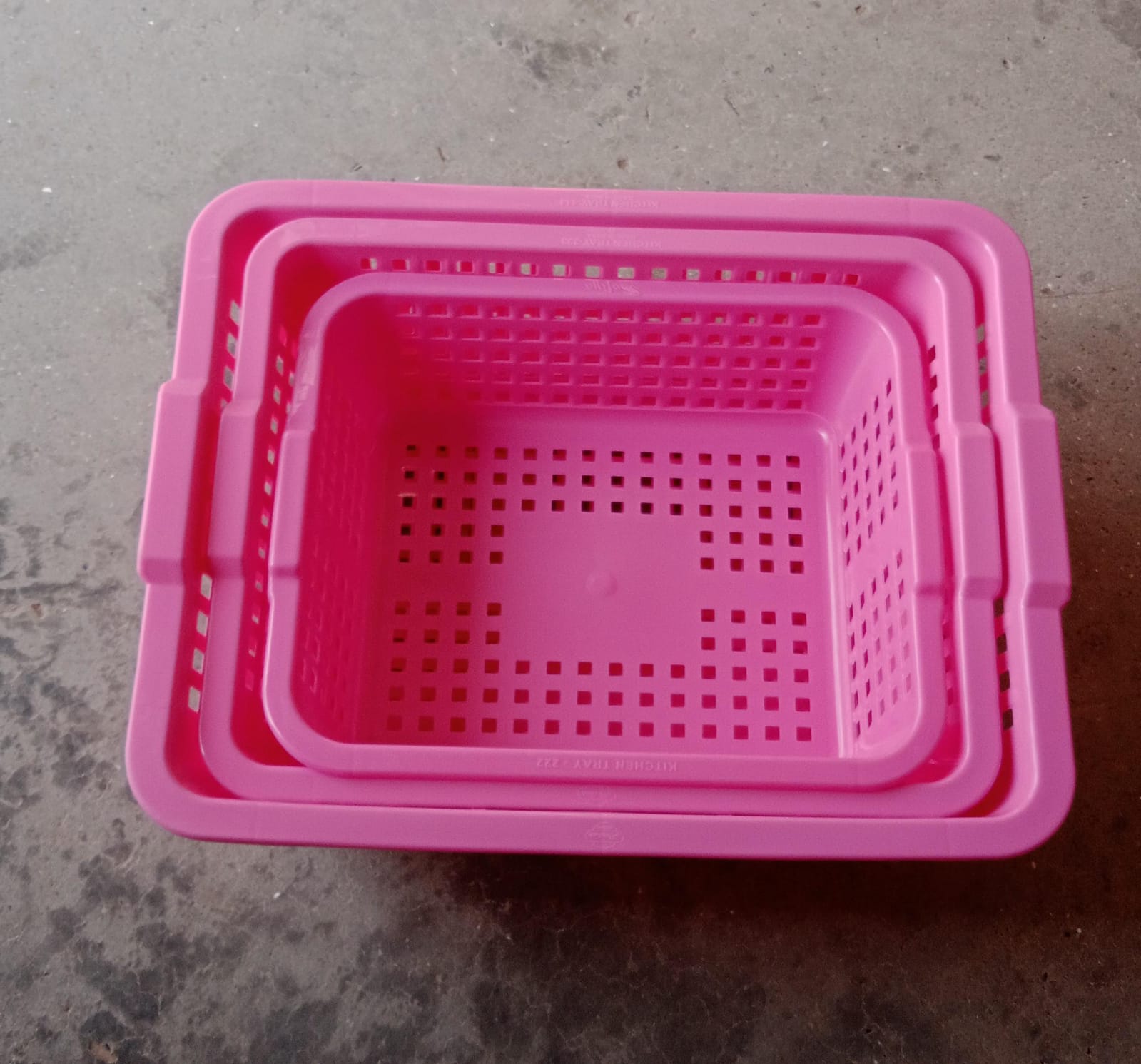 Plastic baskets for fruit, displayed neatly in a kitchen setting.