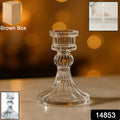 Close-up of transparent glass candle holder with classic pillar design