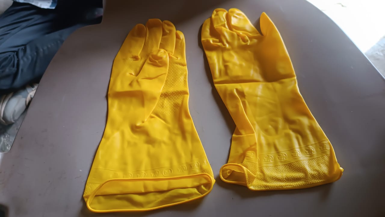 Stack of yellow multi-purpose rubber gloves for home use.