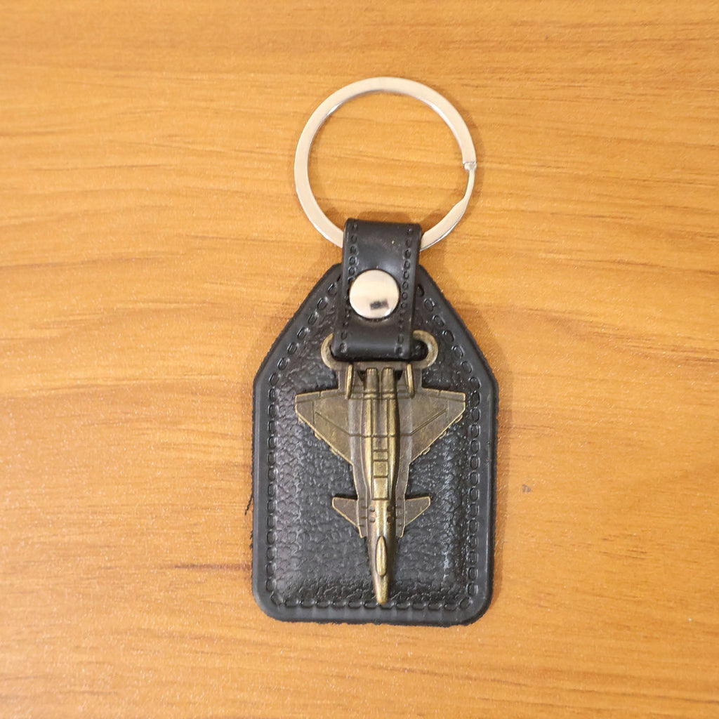 Lifestyle image of aircraft design keychain next to keys and accessories
