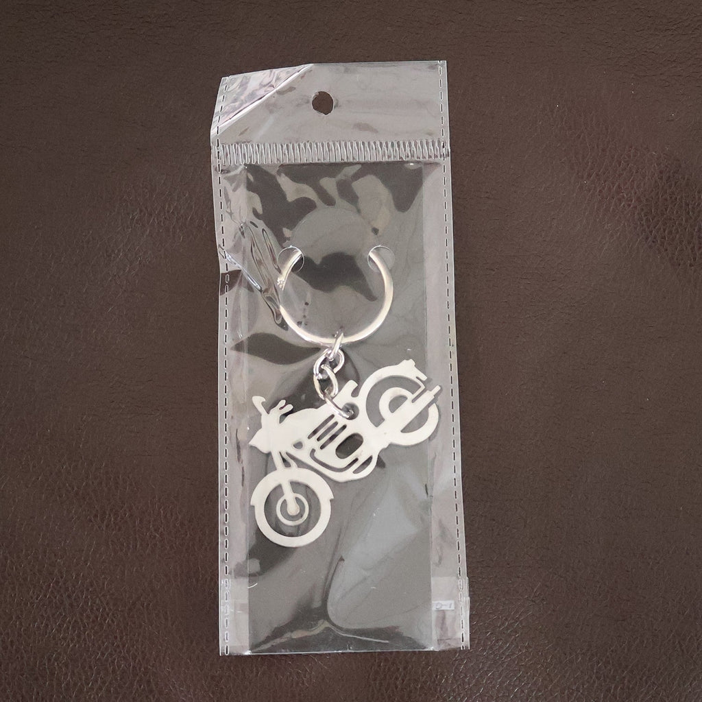 Lifestyle shot of a motorcycle silhouette metal keychain attached to a set of keys.