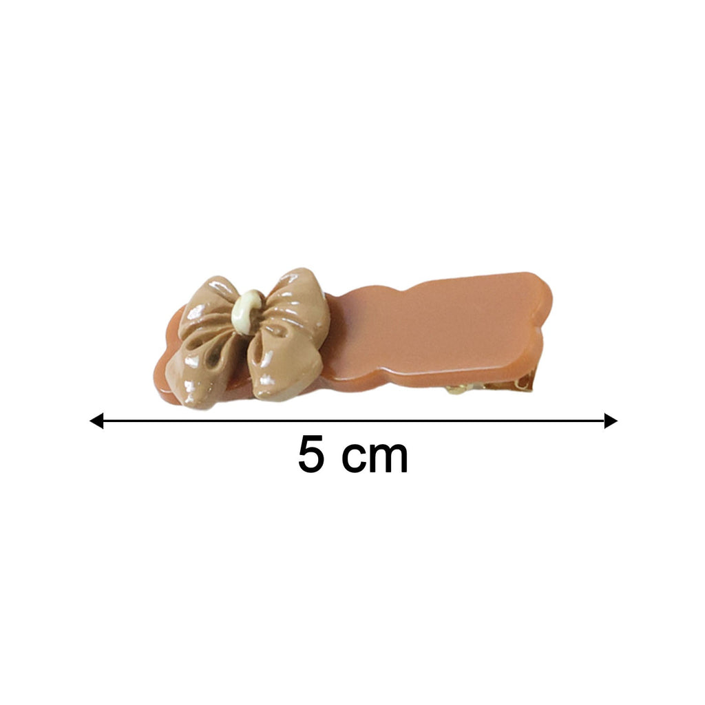 Size comparison image of bow hair clips in solid tones