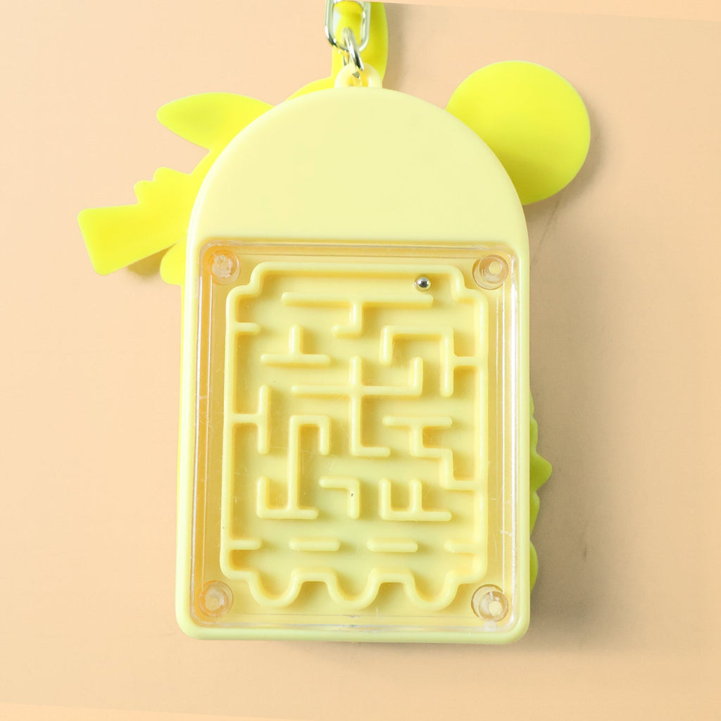 Side view of yellow cartoon character mini calculator keychain with attached bell and ring