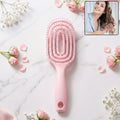 Pink curved vented detangling hair brush designed for effortless hairstyling