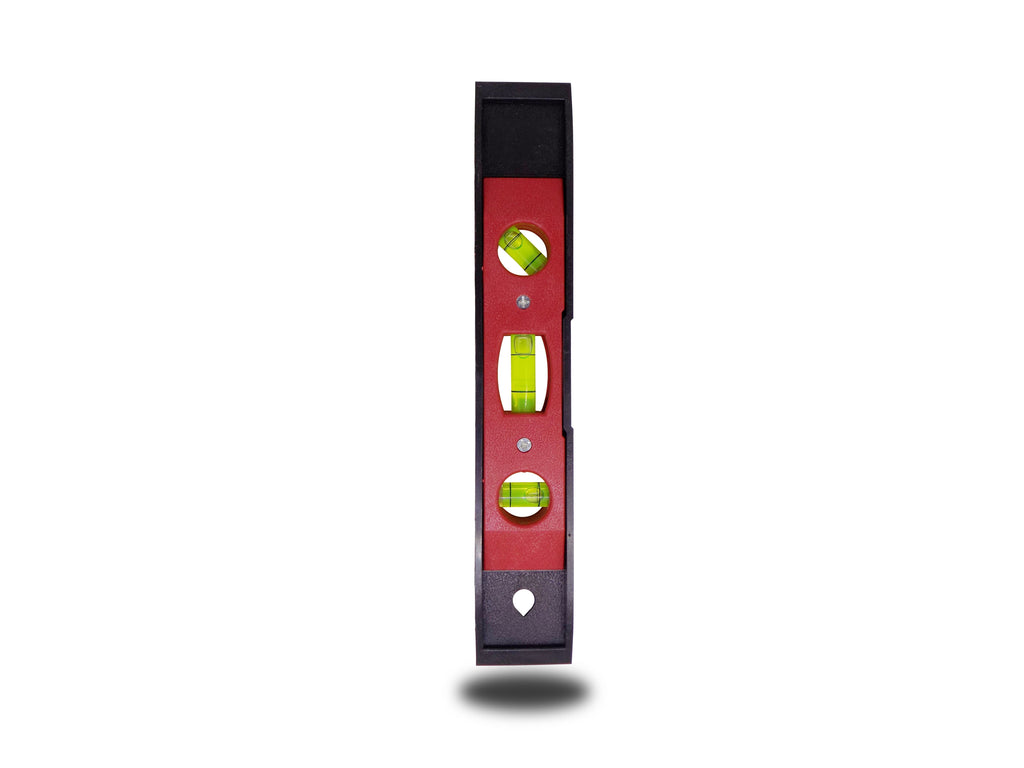 Magnetic torpedo level in hand, demonstrating its ergonomic grip.