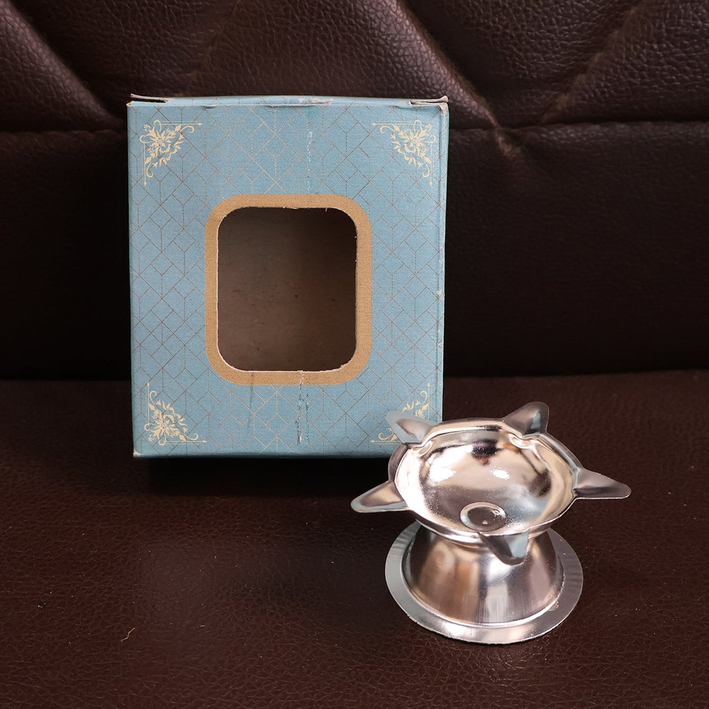 Stainless steel lotus design diya used in home temples for prayer lighting
