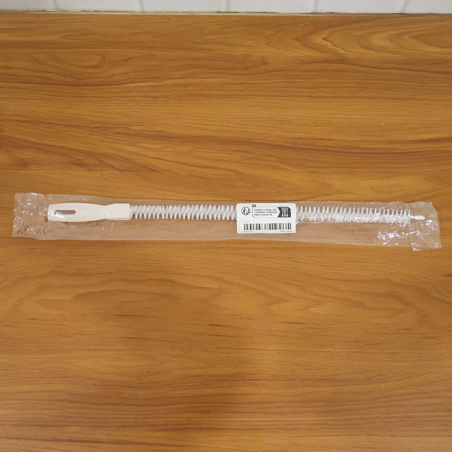 Flexible drain cleaning brush used in kitchen sink for easy clog removal