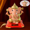 Solar-Powered Dancing Ganesha Idol with detailed gold accents on a decorative base