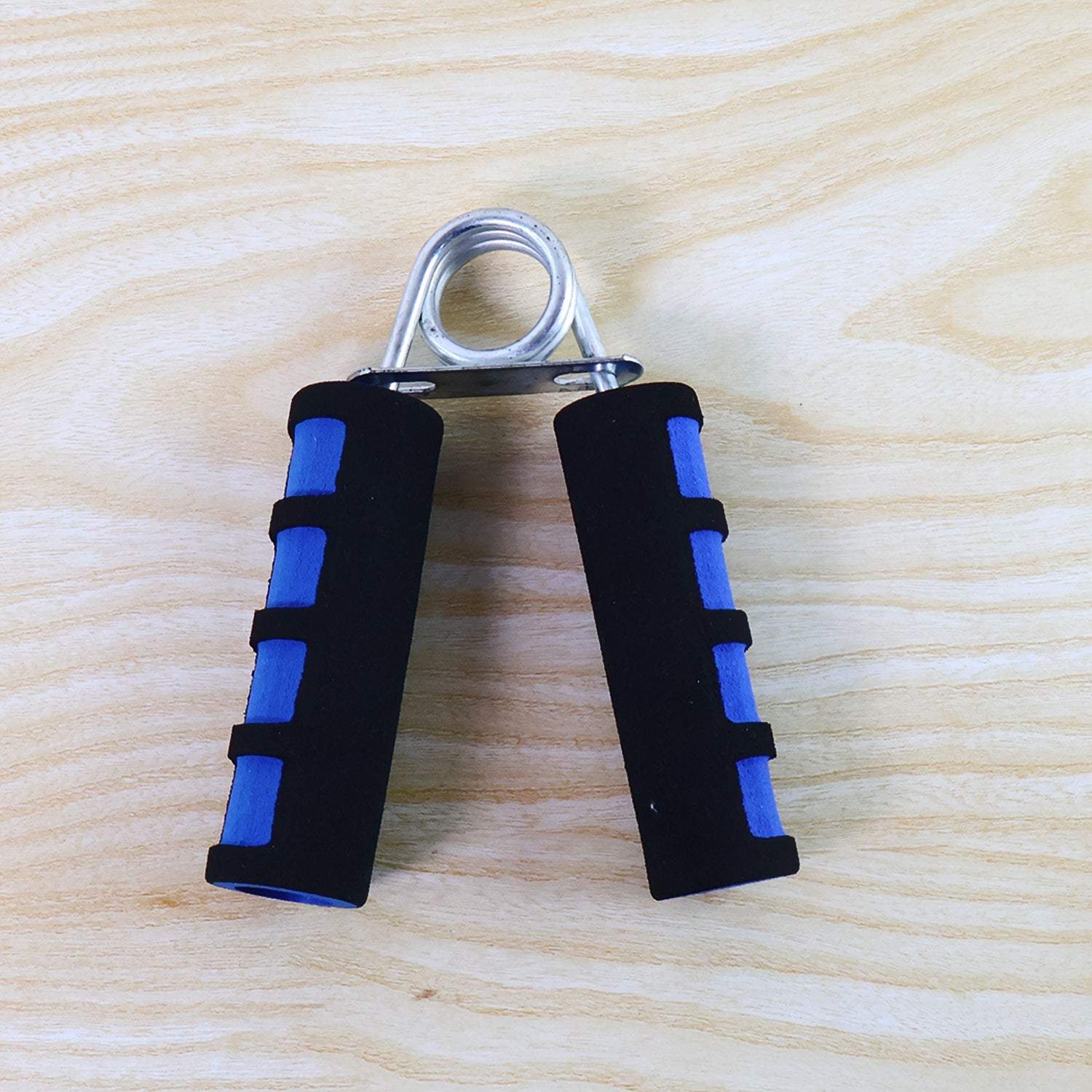 Hand grip exerciser showing foam padded ergonomic handles