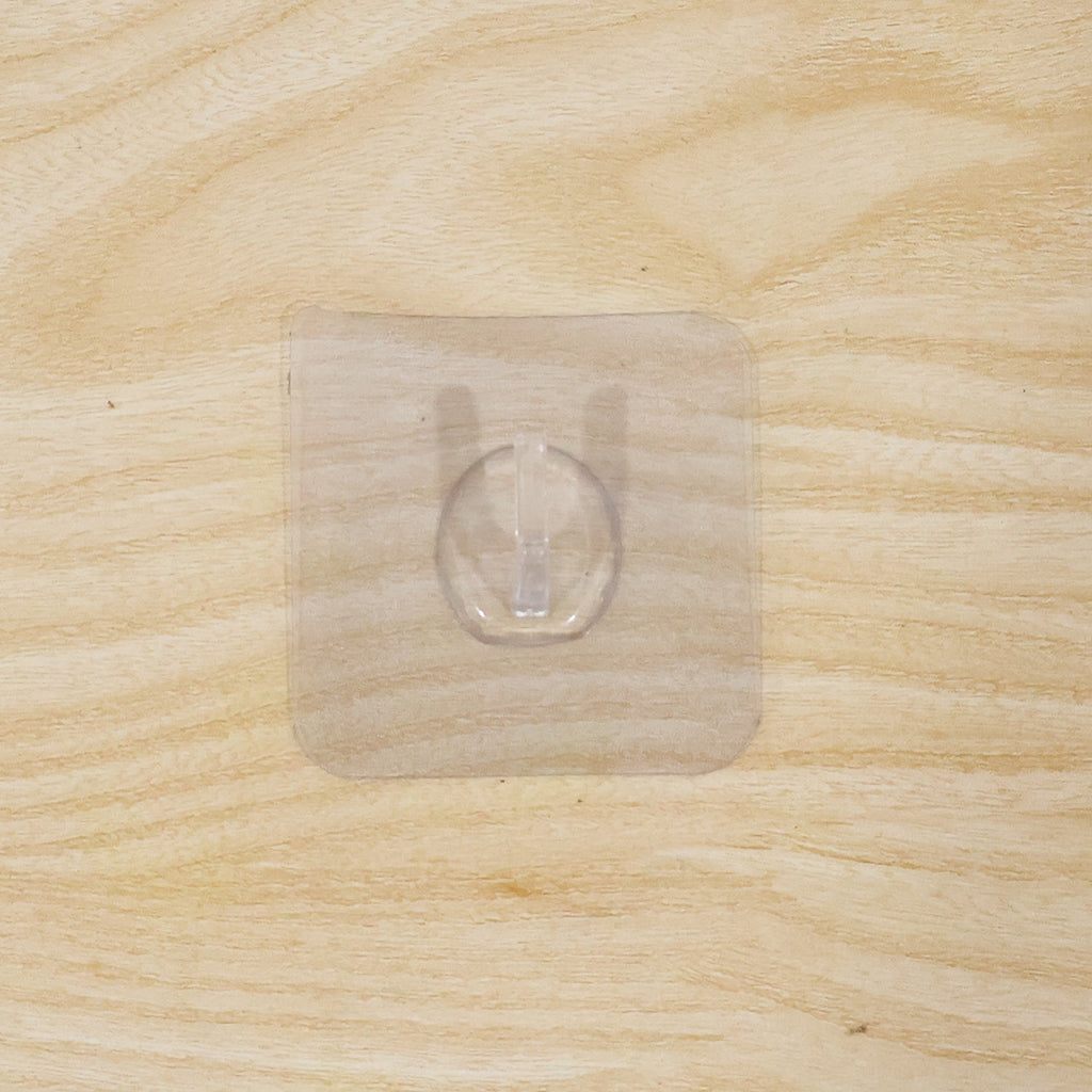 Wall hook on wooden door with transparent adhesive