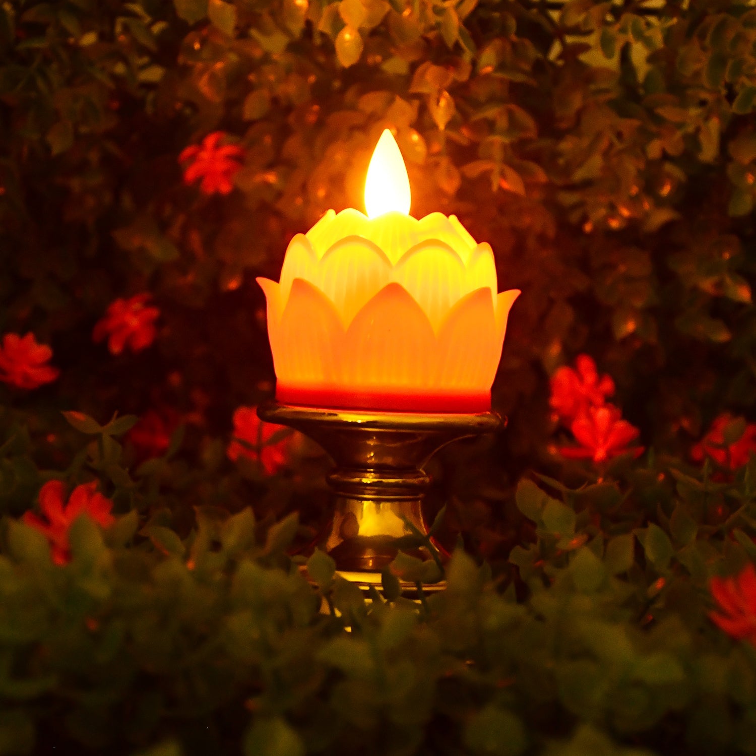 Close-up of lotus shaped LED candle with flickering effect on ornate holder