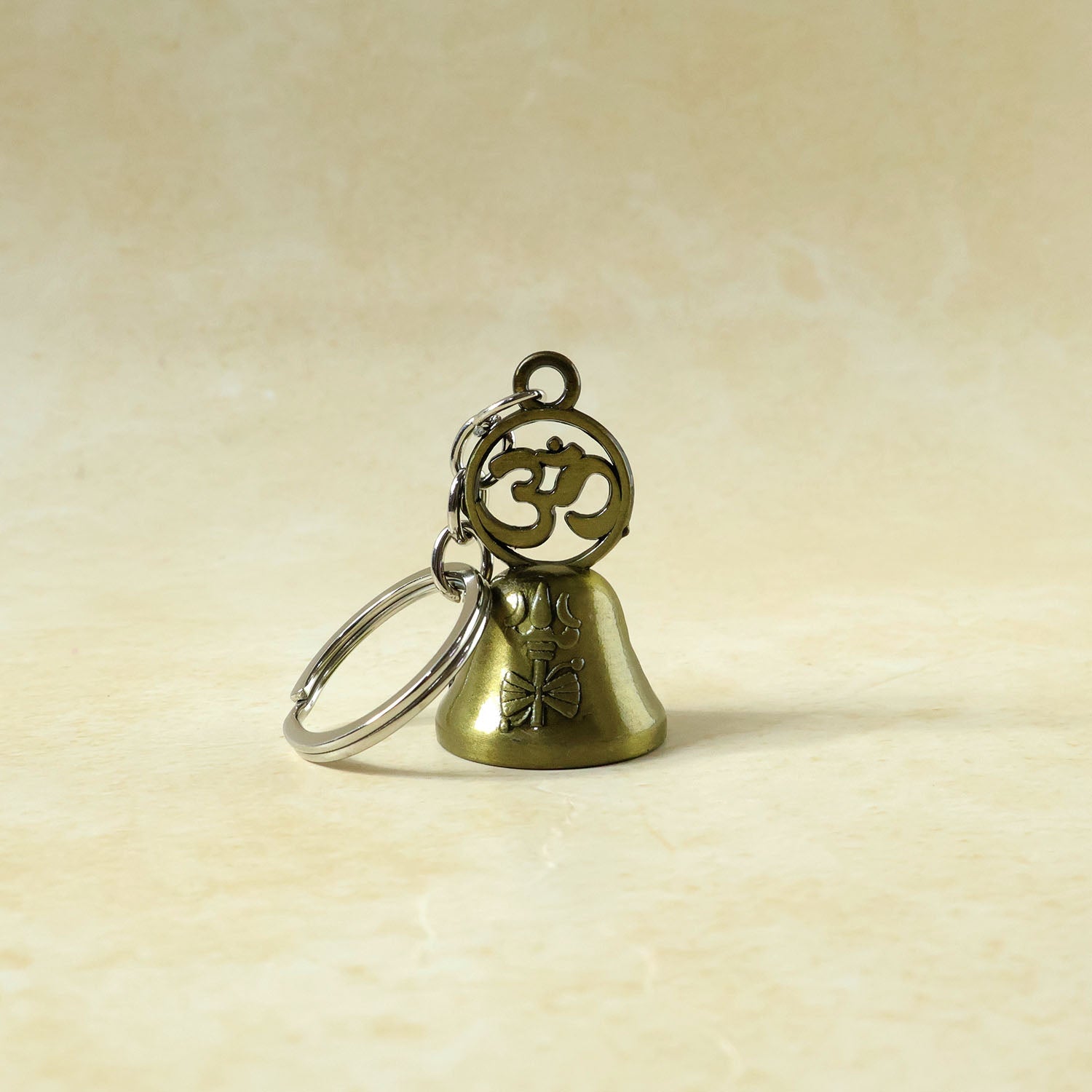 Om temple bell keychain used as decorative bag charm accessory