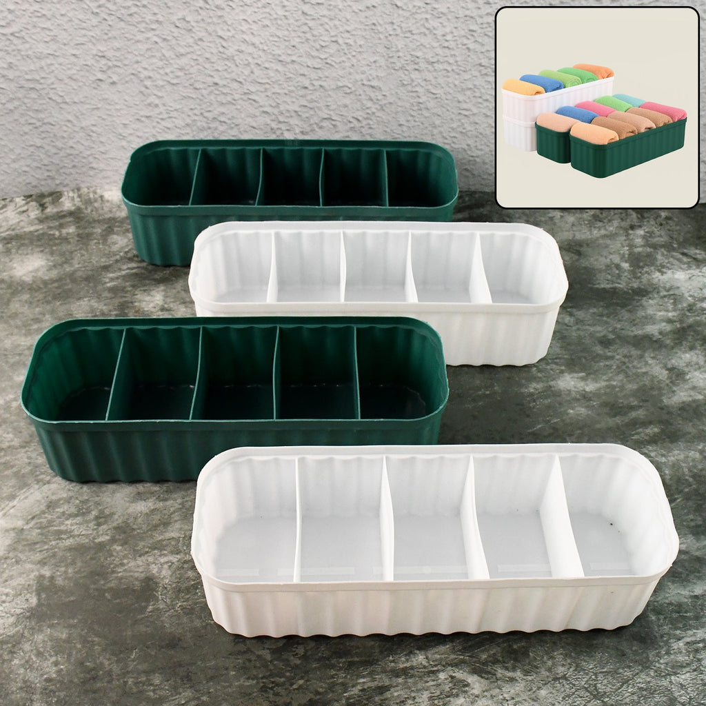 Four 5-compartment drawer organizers neatly stacked, storing socks and underwear.