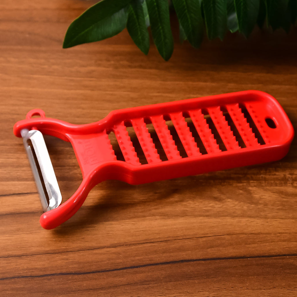 Dual-function grater and peeler tool by Supermom for fresh ginger