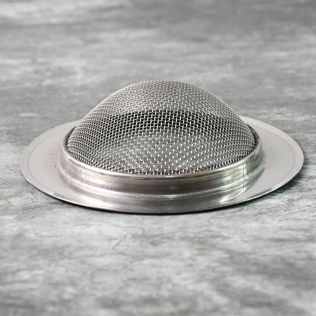 Stainless steel sink strainer trapping food debris during kitchen use