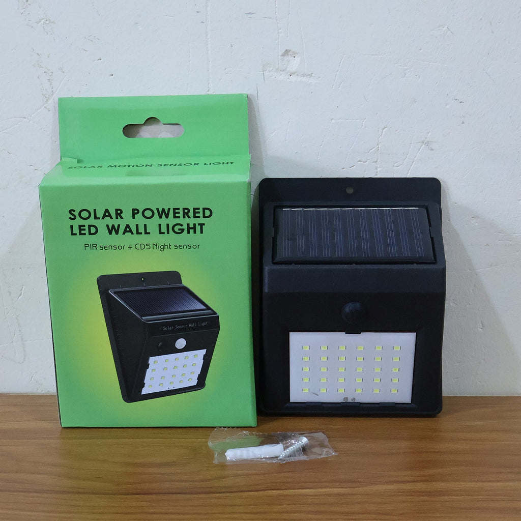 Comparison shot of  solar powered LED wall light on outdoor wall