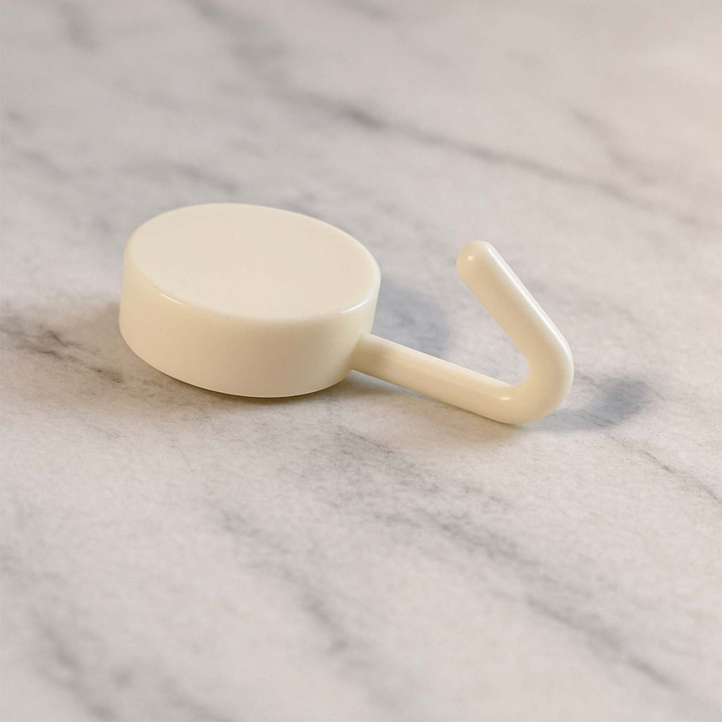 Stick-on round wall hooks mounted firmly on a clean wall