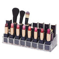 Clear acrylic lipstick holder with 24 sections, showcasing its organized cosmetic storage on a vanity.