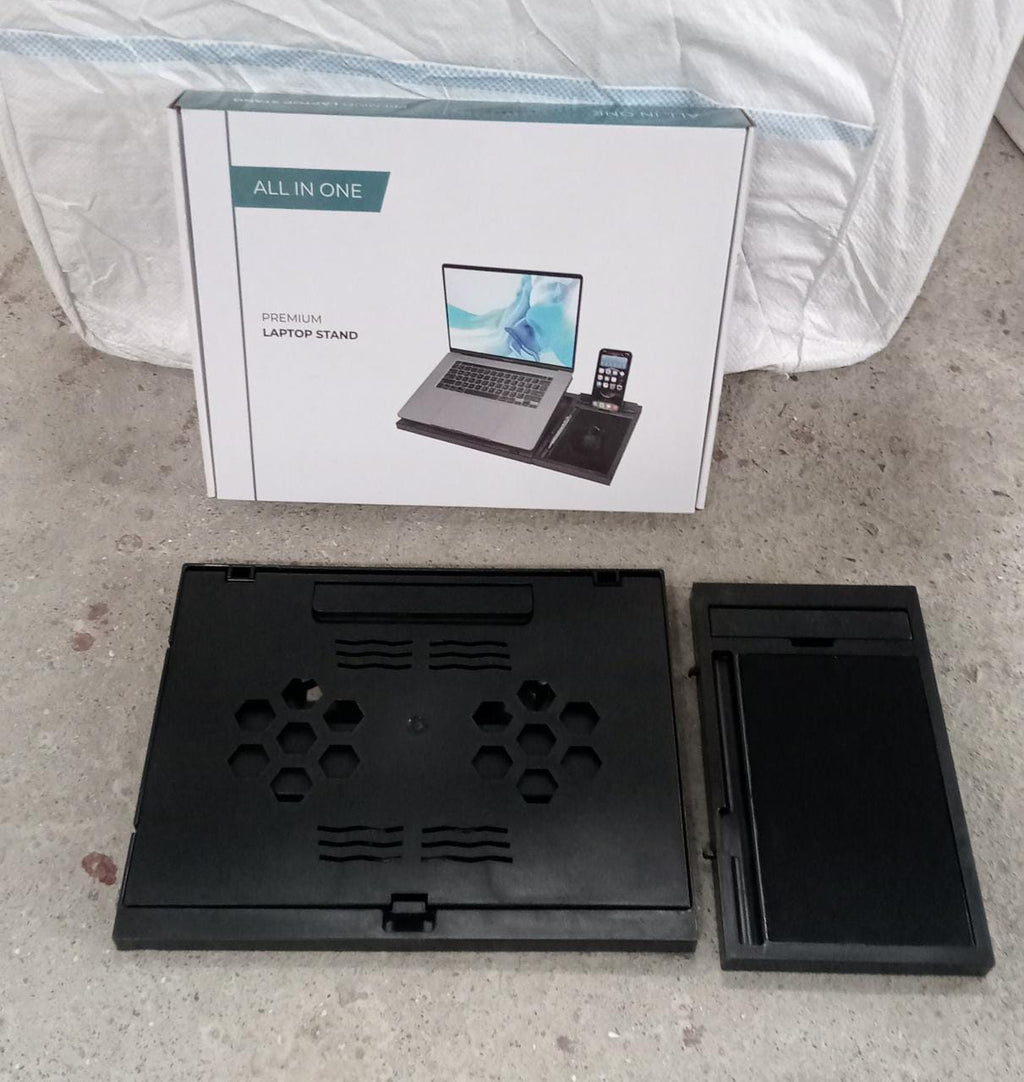 Lifestyle shot of the foldable laptop stand in use with a laptop.