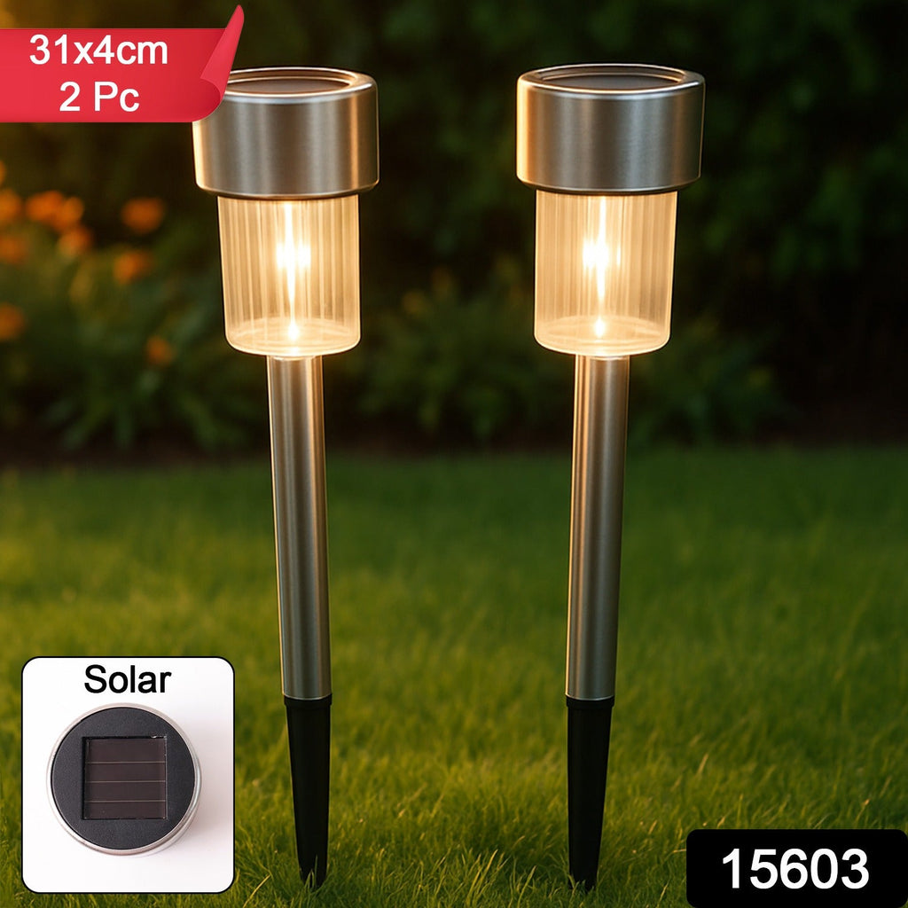 Solar LED outdoor pathway bollard light illuminating a garden pathway