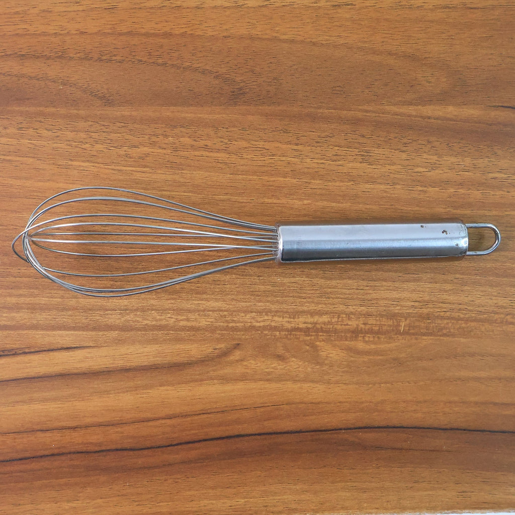 Small stainless steel balloon whisk on white background