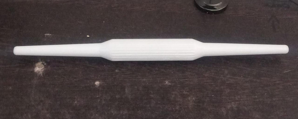 Sturdy plastic rolling pin with anti-skid base for stable operation.