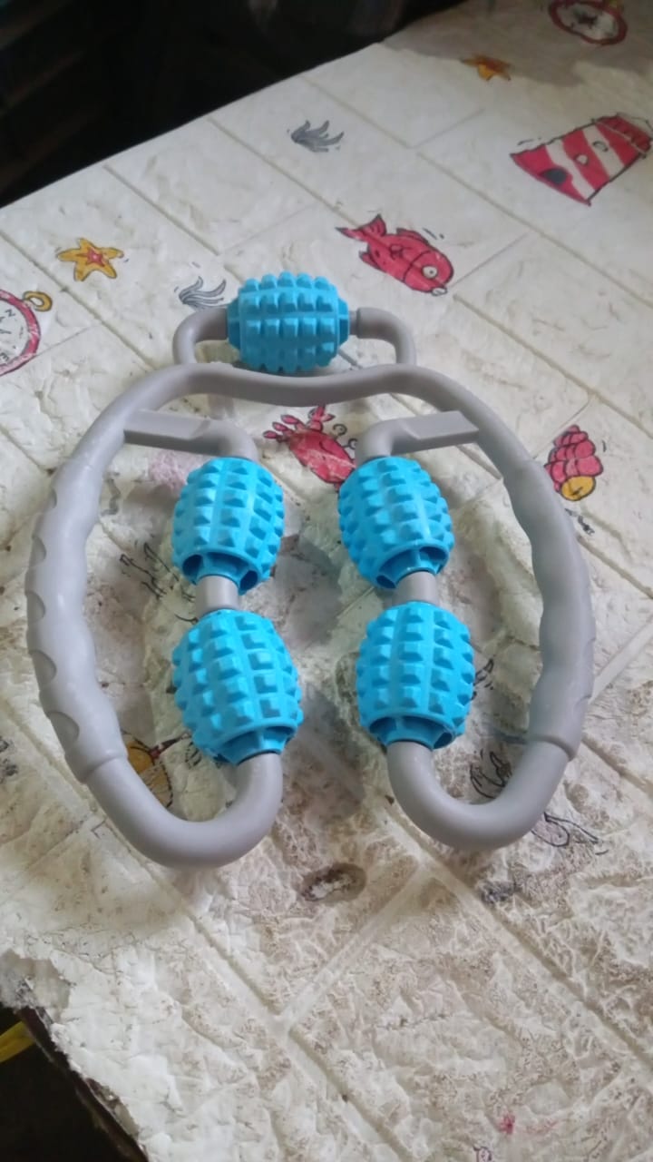 The muscle massage roller in action, targeting a user's arm for muscle relaxation.