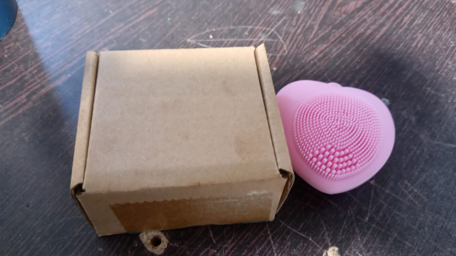 Silicone exfoliating face brush in heart shape for women.